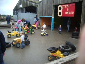Tractor barn, with children driving the tractors