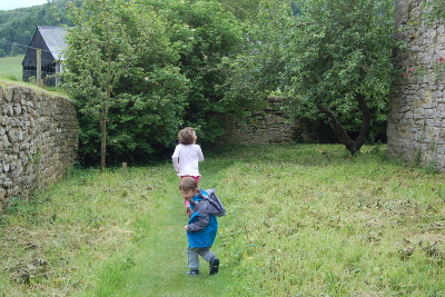 Stokesay Castle day out with the children - kids running around the moat walk